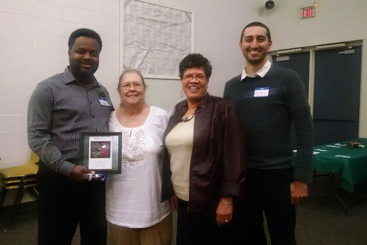 Jermaine Jackson, Brenda Hughes, Judi Rambow and Fernando Ospina of the Kalamazoo Public Library’s Antiracism Transformation Team accept an award from ERACCE.