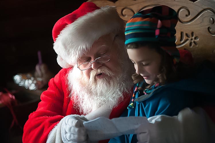 Santa listens to a Christmas wish list. Photo by David Trumpie.
