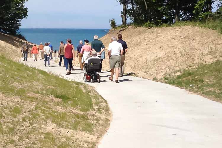 Beach goers take the barrier free walkway through Pilgrim Haven 