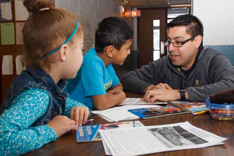 Israel Flores with reading buddies Tori and Joel  Photo by Susan Andress