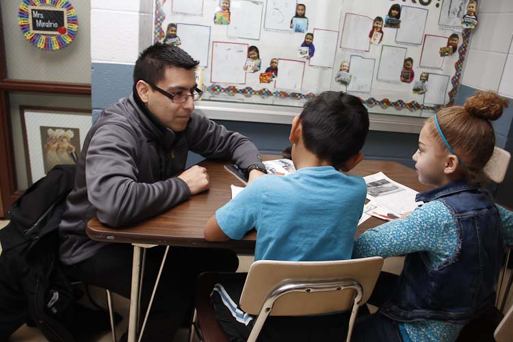 Israel Flores with reading buddies Tori and Joel  Photo by Susan Andress