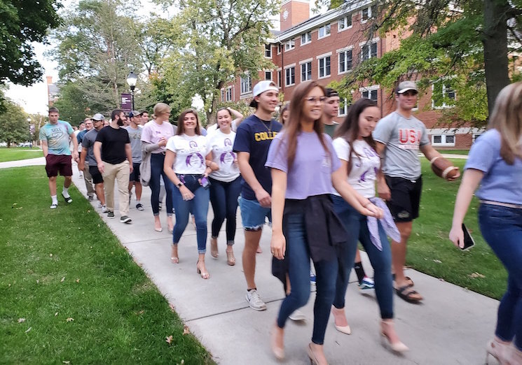 Students attending Albion College participate in a walk to end Domestic violence abuse on their campus.