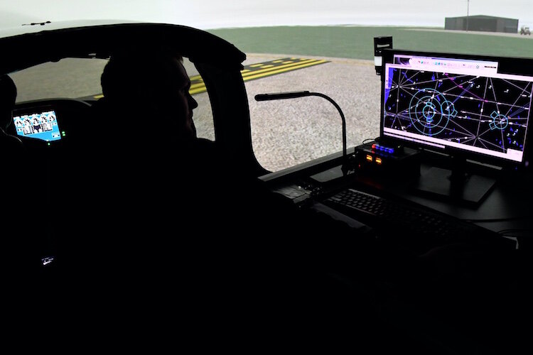 An instructor and student prepare for takeoff in one of the college’s flight simulators.