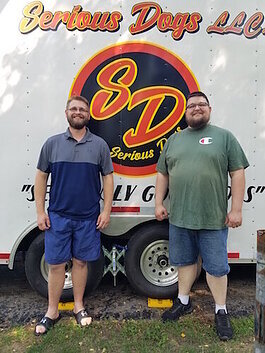 Thomas Woodin, at left, and his brother James, in front of their food truck in Battle Creek.