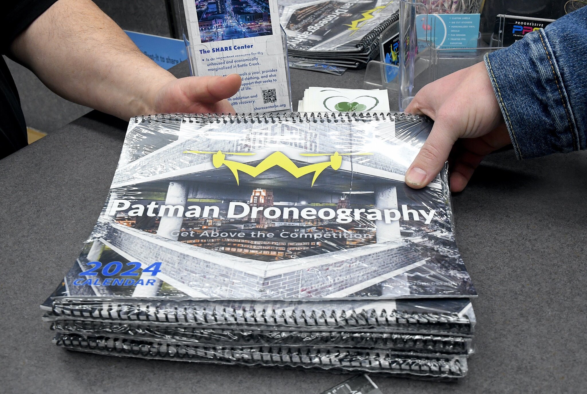 Patman Droneography’s 2024 calendar is printed at Progressive Printing. Progressive Printing are printing Patman Droneography artwork for a $50 donation to the SHARE Center. 5 Robert Elchert is the executive director or the SHARE Center.