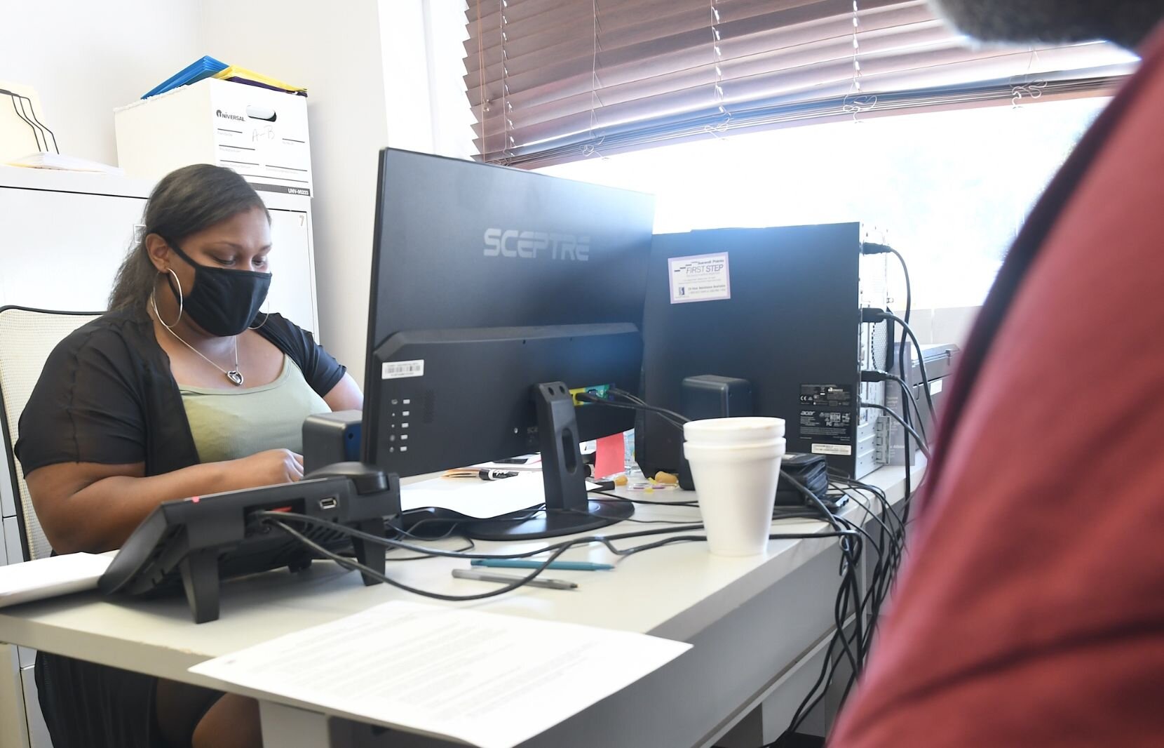 Iesha Parson, employment and benefits coach at the SHARE Center, helps people getting identification at the SHARE Center.