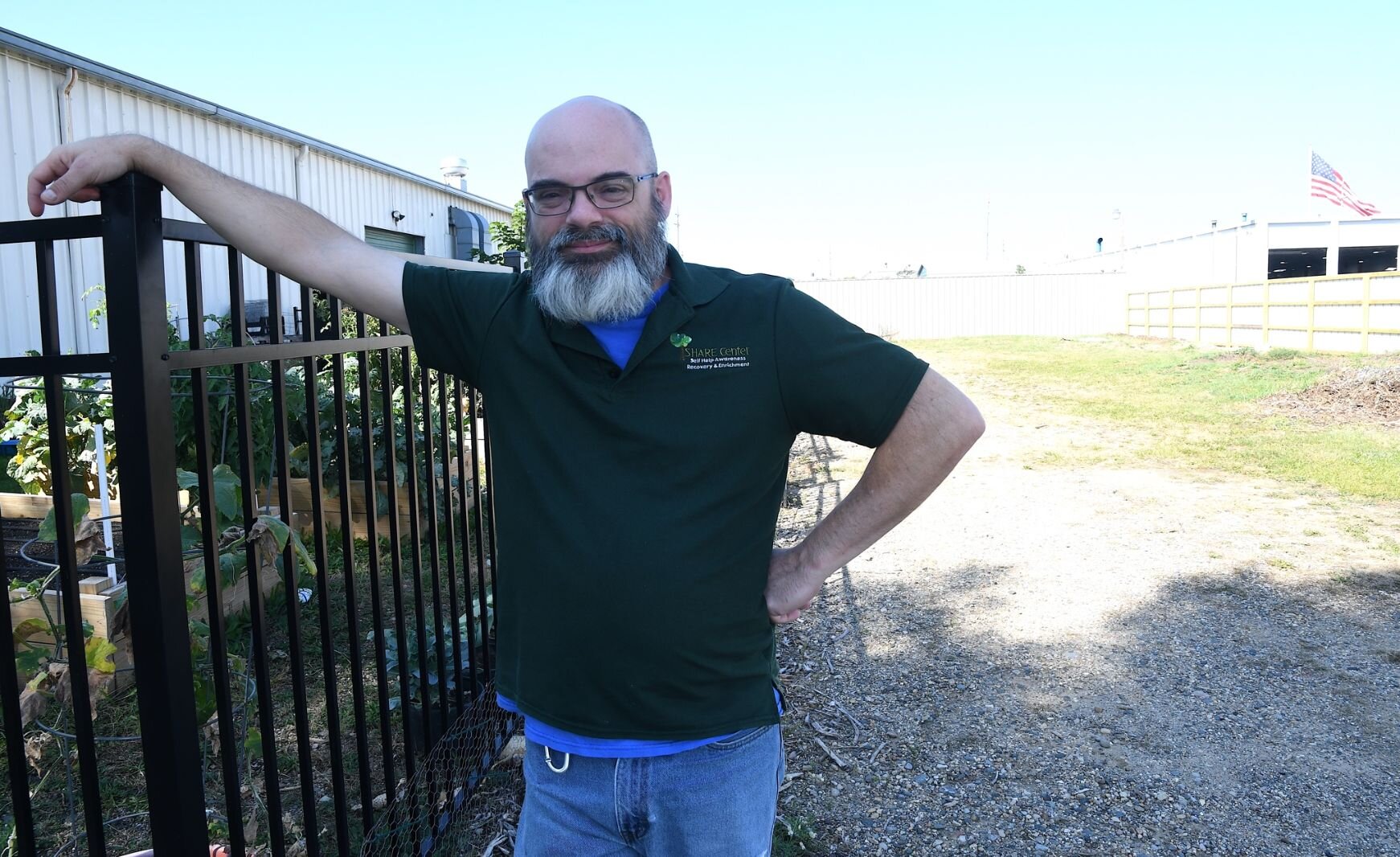 Robert Elchert, executive director of the SHARE Center, stands by a space he hopes will become a developed open recreational space, instead of a vacant field.