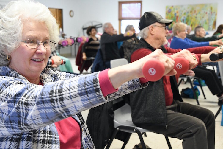 Before social distancing, Jean Kline and others work out during a Senior Health Partners exercise class at the Trinity Neighborhood Center.