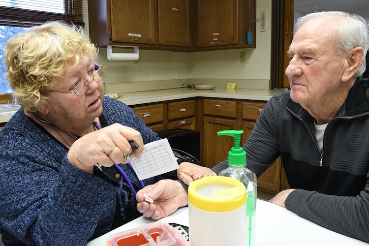 Peg LaForge, LPN, does a participant assessment with John Tramel.