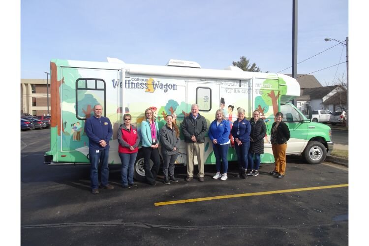The Calhoun County Wellness Wagon staff pose in front of the new mobile healthcare unit.