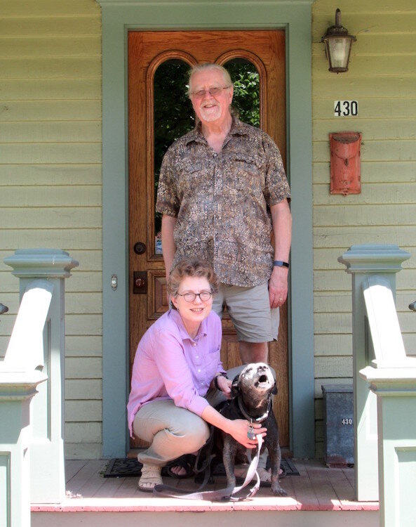 Sharon Carlson and her husband Tom Dietz are shown outside their 1880s vintage home with their dog Frank.