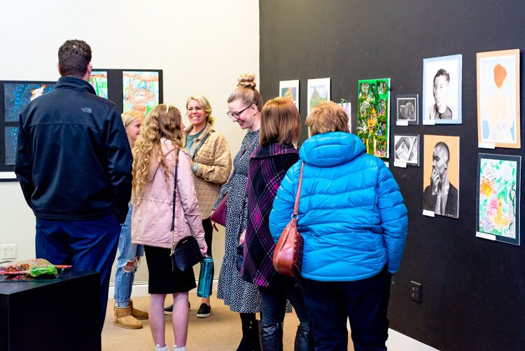 Many visitors and families came to admire student work at the opening of the youth show, "Class Act."