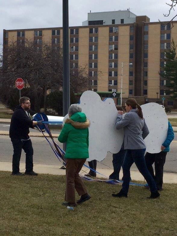 SURJ members working on an art installation in Battle Creek to speak out about the Flint Water Crisis. 