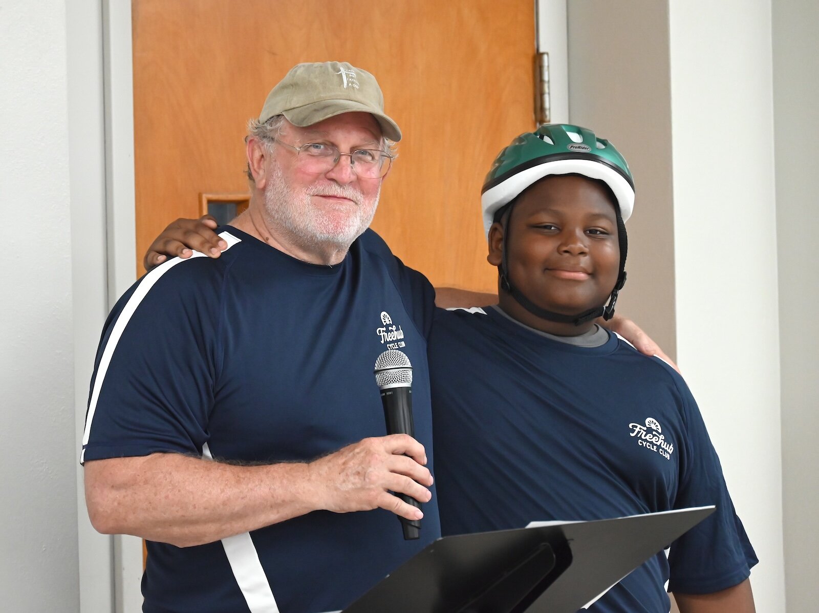 Mentor Denny Hunt and A.J. Bridges pose for a graduation photo.