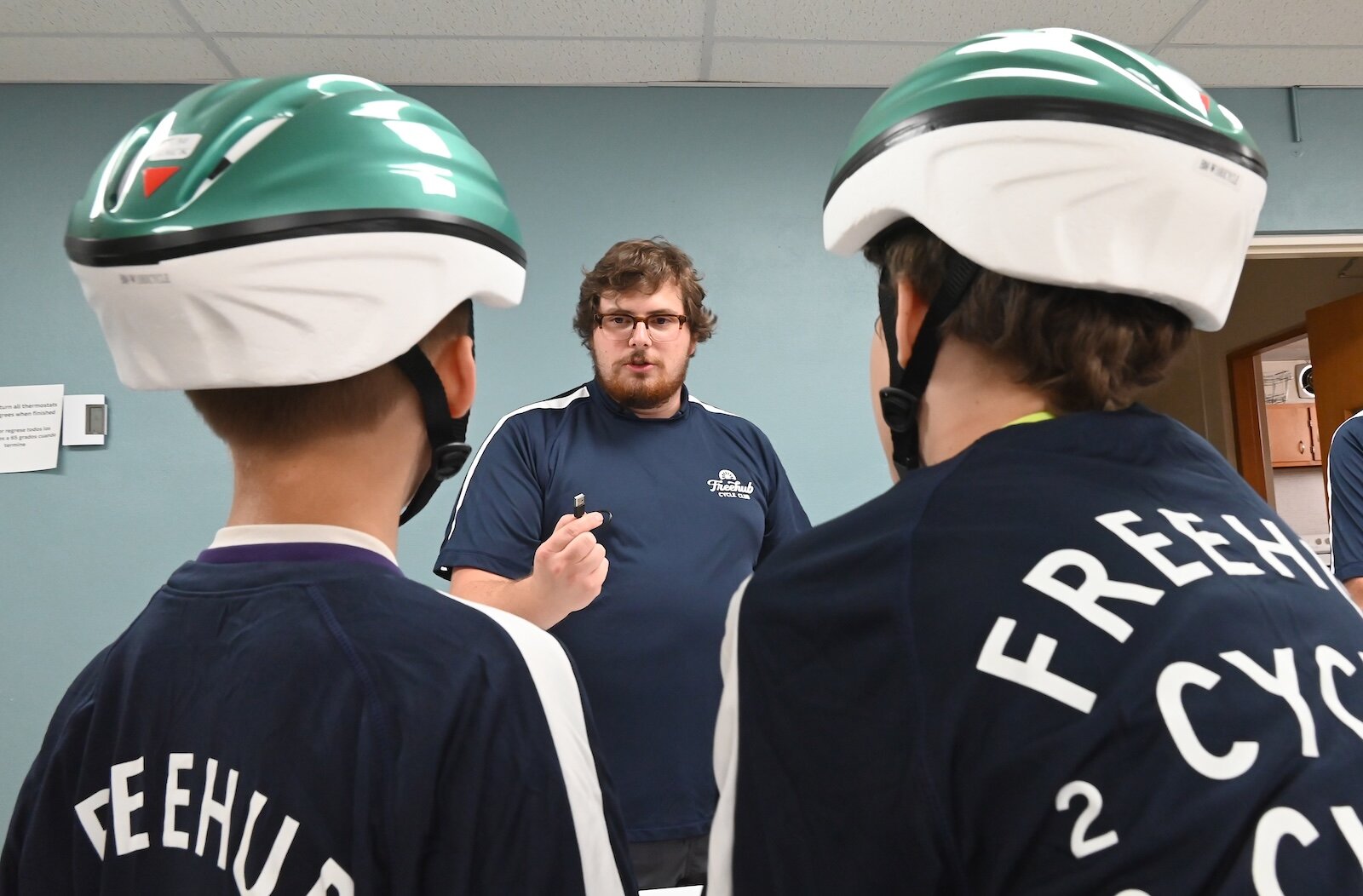 Nick Linsley explains to students how their new bicycle lights work.