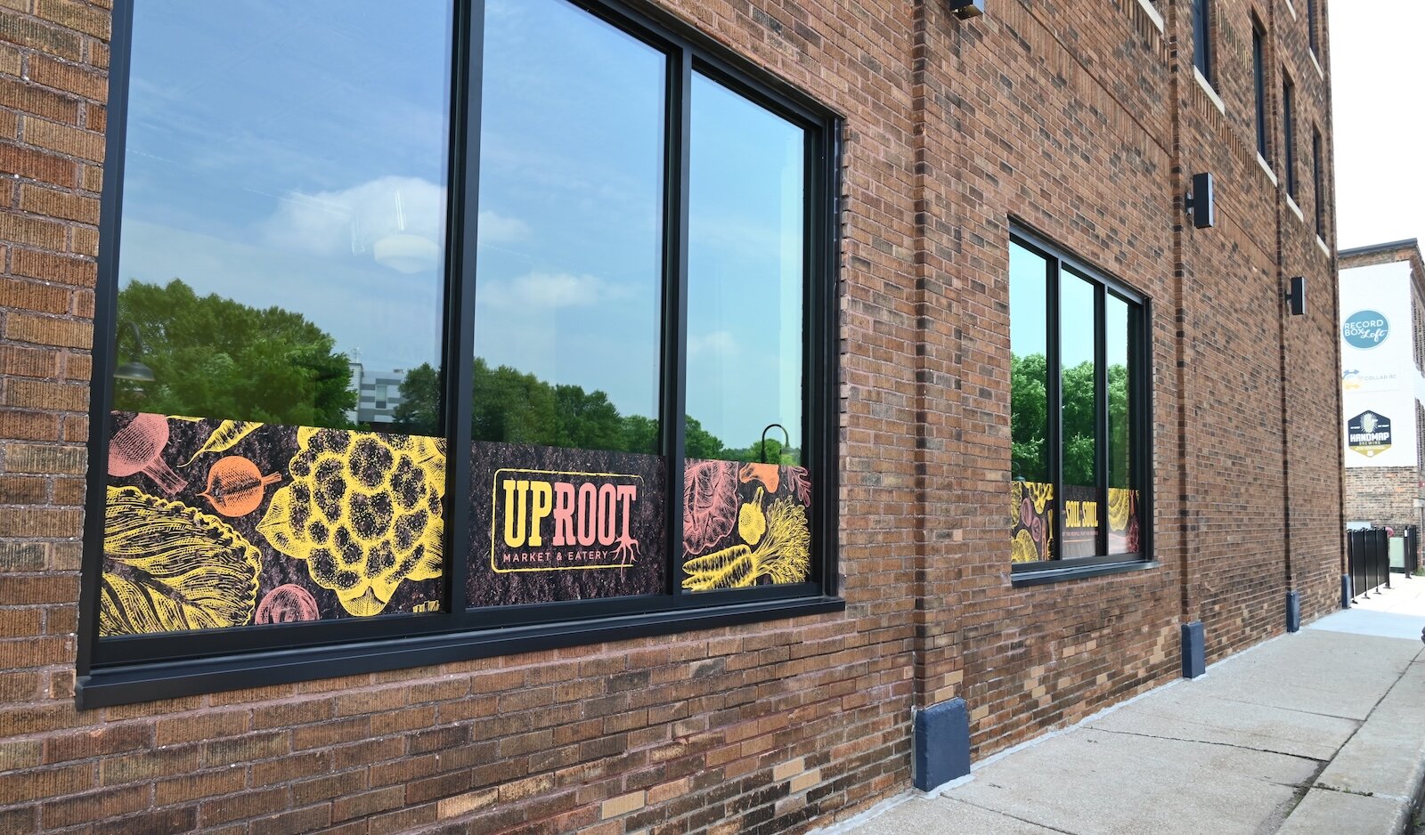 Looking down Carlyle Street from the Uproot Market and Eatery, one can see the Record Box Loft and Handmap Brewery.