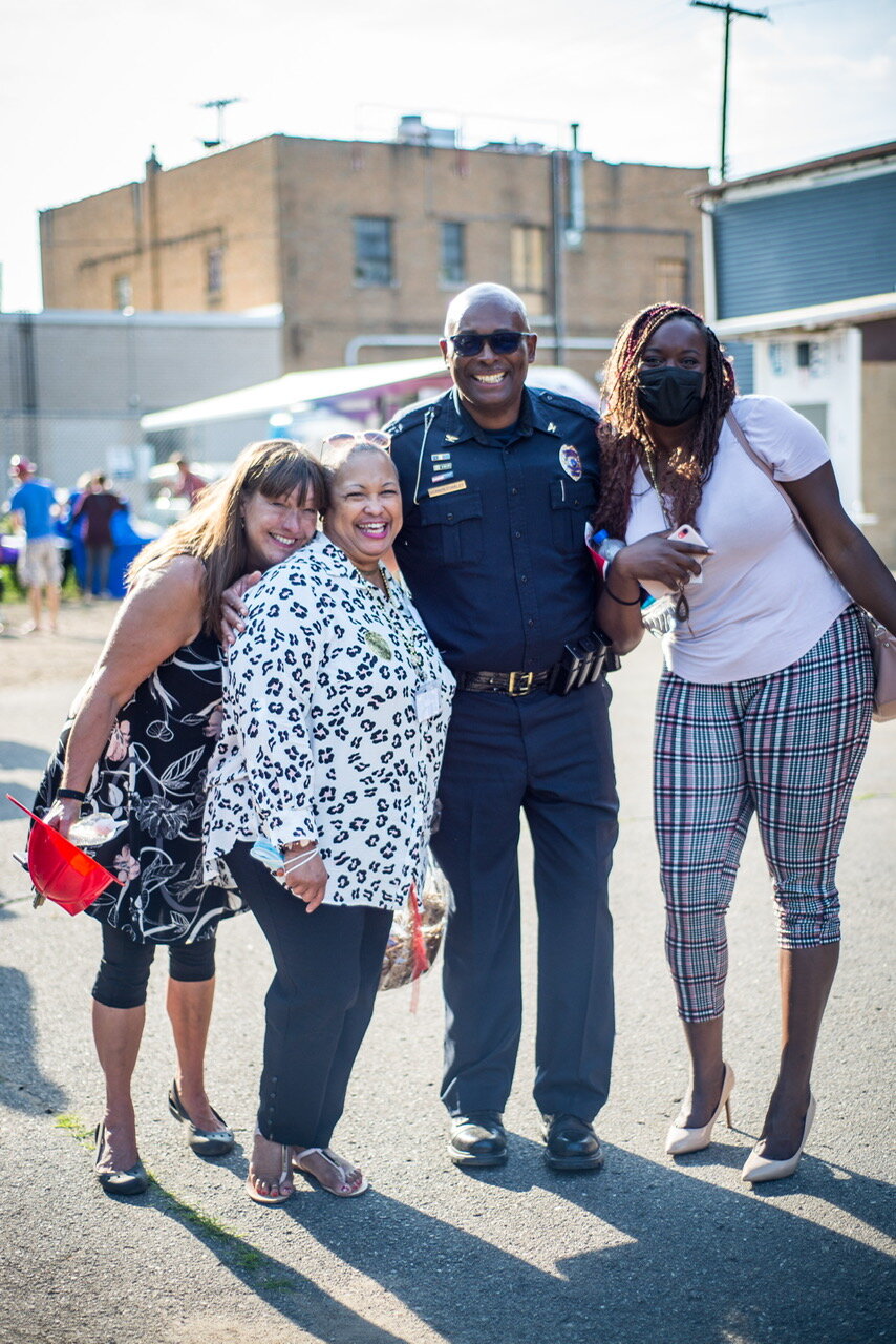 From left, Tammy Taylor shares a happy moment in August with Edison Neighborhood Board Trustee Vanessa Collins-Smith, Kalamazoo Public Safety Chief Vernon Coakley and Kalamazoo County Continuum of Care Associate Tiyanna Williams.
