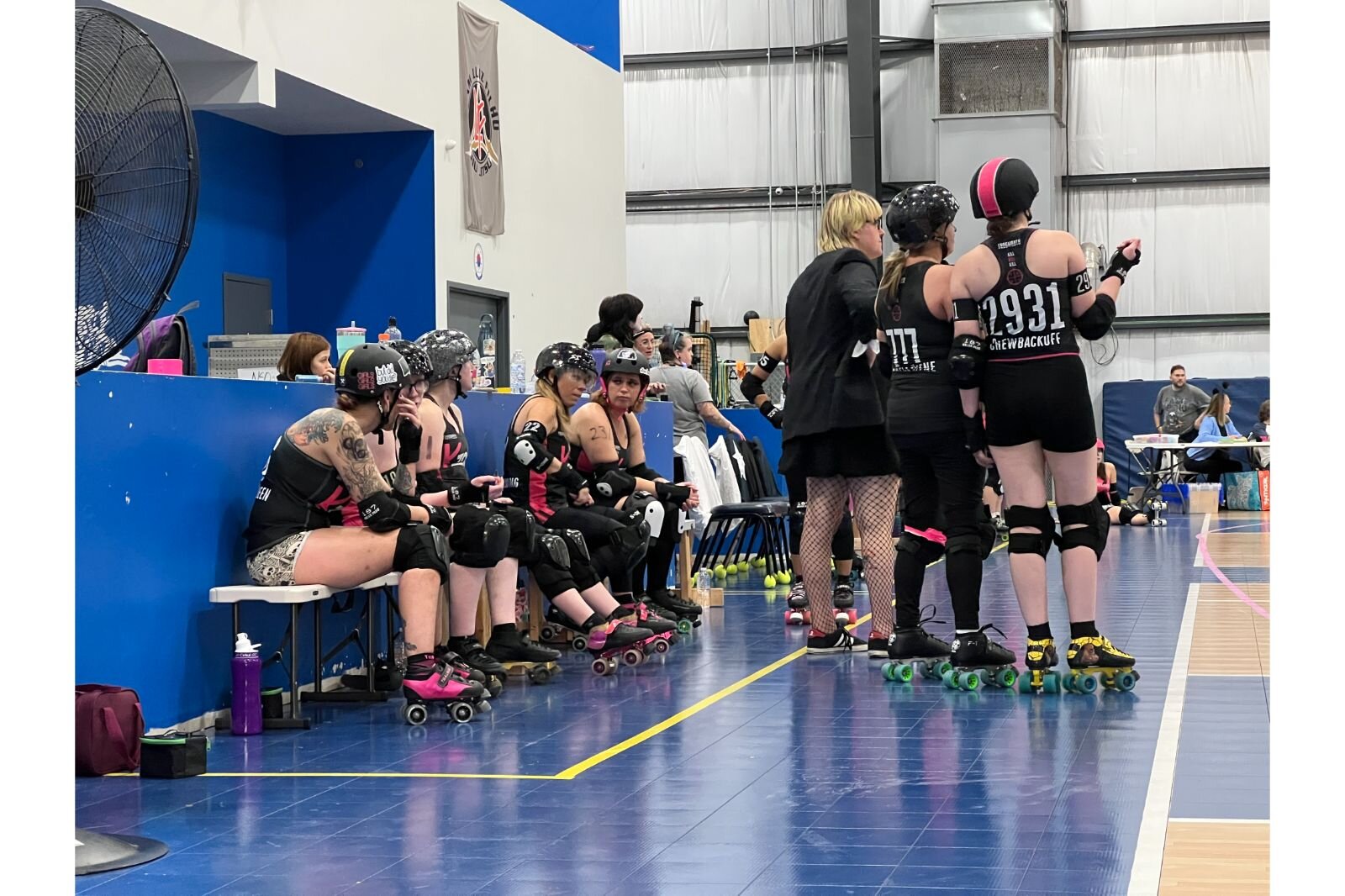 Risk and some of her squad members watch as the bout goes on in front of them. 