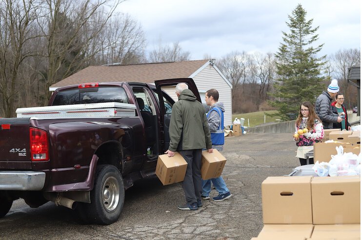 Volunteers loading food into a truck