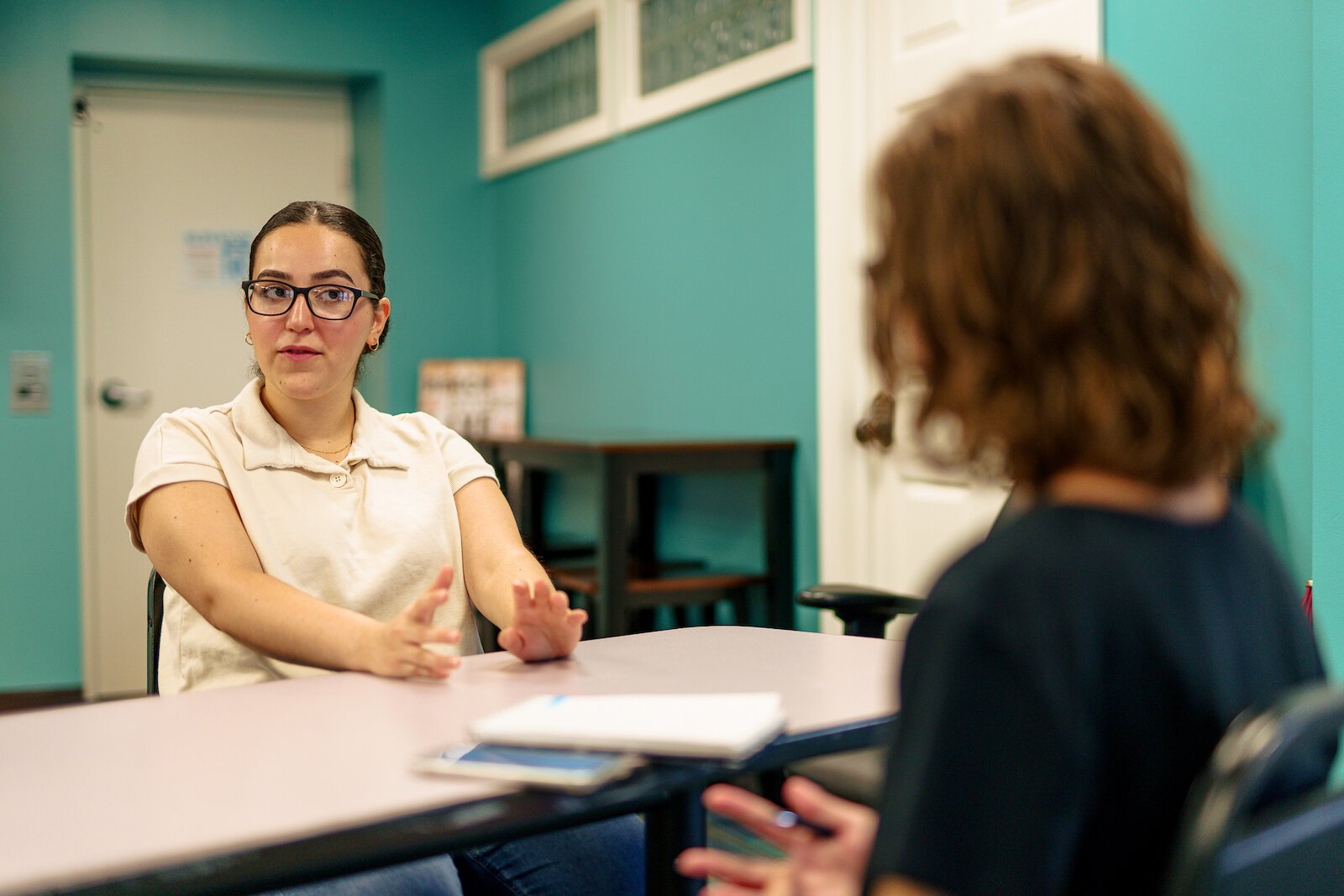 Haila Jiddou (left), told reporter  Cori Osterman (right), “I just like to see them have fun and enjoy themselves and get to know each other.”