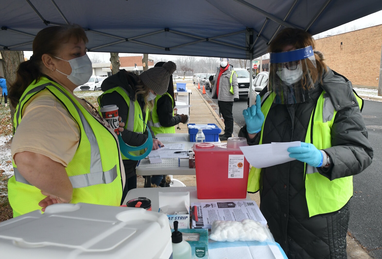 Calhoun County Health Department employees prepare to give a dose of Pfizer/BioNTech COVID-19 vaccine in Battle Creek Friday morning. 