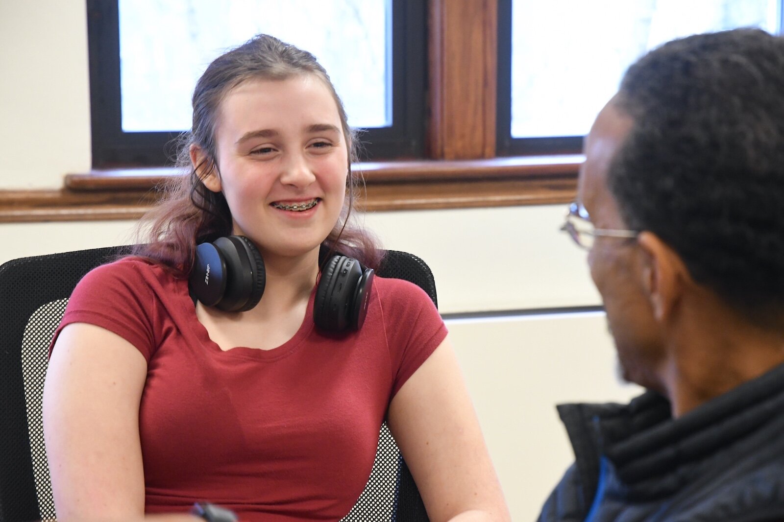 Lila McCarthy talks with her mentor, J.R. Reynolds, at a Voices of Youth Battle Creek workshop.