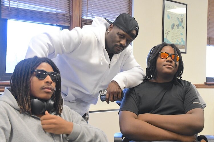 Elisha Willis, a Battle Creek Central junior (left) and Cordell Barnes, a Battle Creek Central Junior (right) created a podcast with their mentor Gerald King (center).