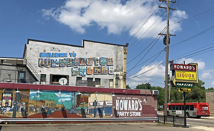 Two murals on the south side of Washington Square welcome visitors.