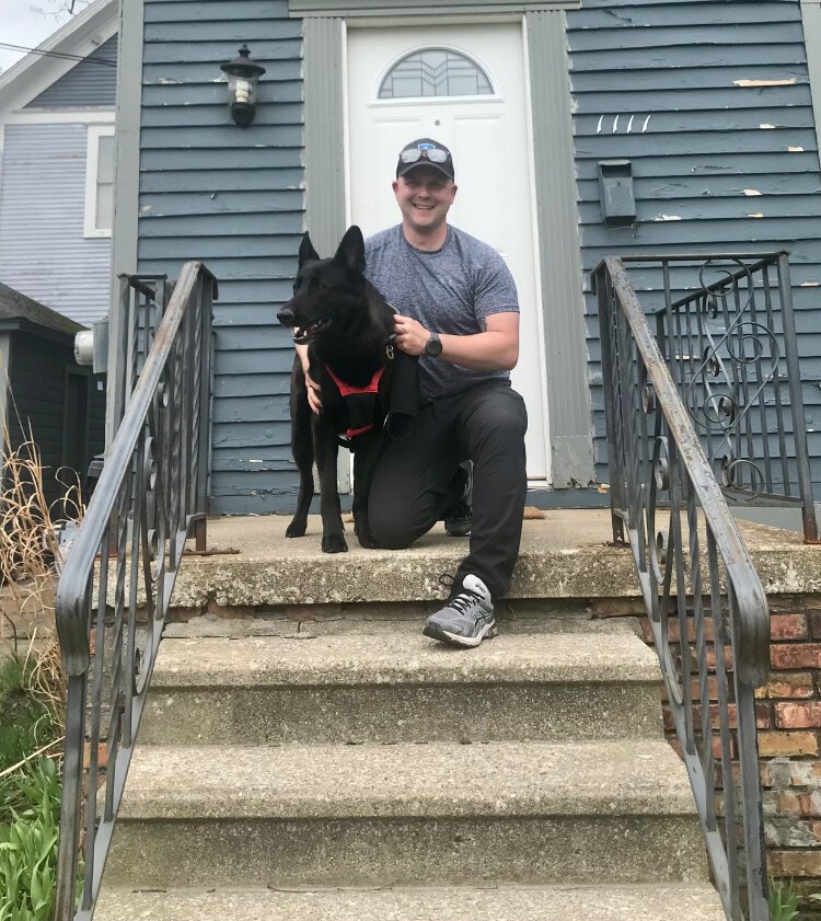 “It’s super quiet,” Matt Hills says of West Douglas. People in the area are pretty respectful and don’t get in each others way. He is shown with his dog “Frejya” outside of their two-story home on Jefferson Avenue near Douglas Avenue.
