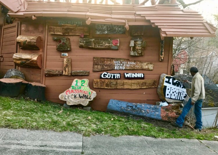 John Lewis lets the sculpted messages outside his Prairie Avenue home and garage do the talking. The 63-year-old retiree likes to carve words of wisdom, religious affirmations and witticisms on wood and place them on exterior of his garage and fence.