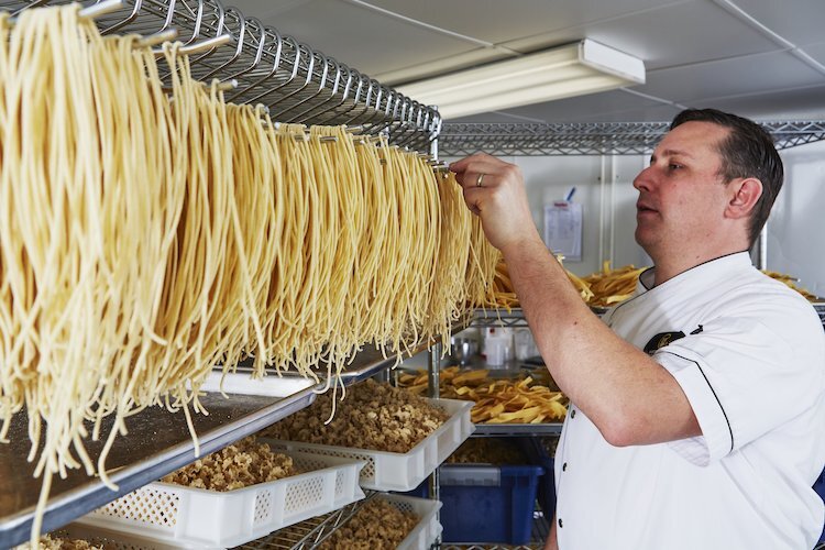 Chef Murray prepares pasta in home pasta shop for his business,West Michigan Pasta & Provisions.