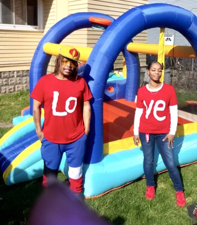 Michael Wilder and his wife Dominique wear their “LOVE” shirts outdoors on the first April day that Michael was cleared of the coronavirus,