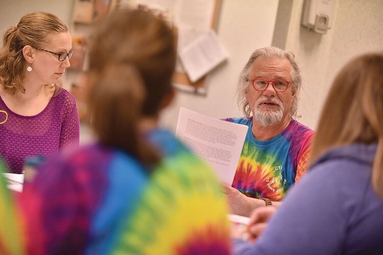 James Henry, right, discusses children's cases with CTAC staff members. 