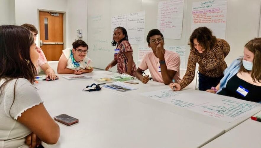 Jacqueline Slaby helps youngsters document projects they'd like to see in their neighborhoods during a 2022 youth summit at Western Michigan University.