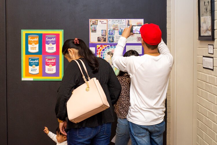 Many visitors and families came to admire student work at the opening of the youth show, "Class Act."