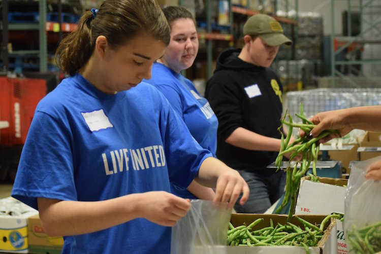 The United Way at work before the coronavirus hit. This is from 2019 Youth Day of Caring, where a group of Battle Creek high school students volunteered at the South Michigan Food Bank.