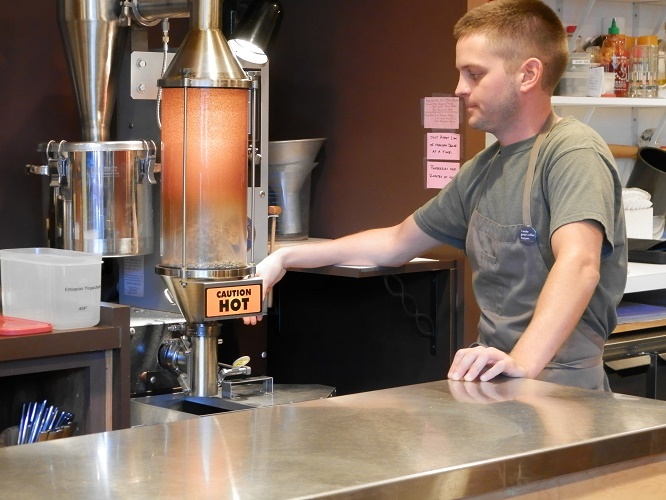 Barista Justin Comer demonstrates how they roast the beans right in the shop.