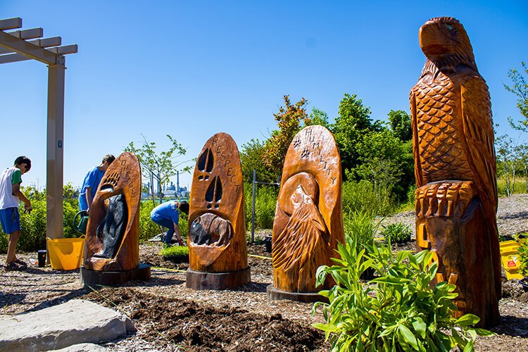Shawnee Ojibwe artist Garrett Nahdee created the Seven Grandfather Teachings sculptures featured at the Blue Water River Walk. 