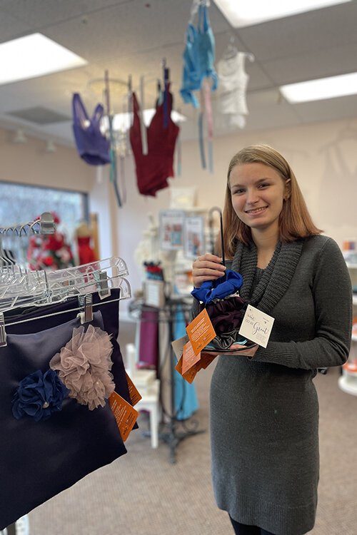 Abby Mitchell showcases hair scrunchies made of material from unsold dresses.