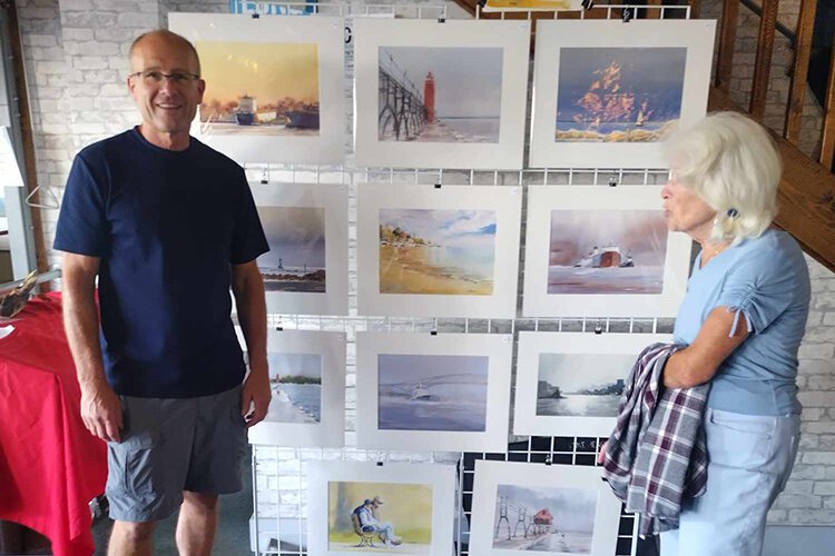 Local artist Mike Henry and his exhibit during Marine City Art Drift.
