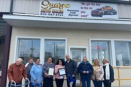 Noel Suarez (fourth from the right) and the Blue Water Area Chamber of Commerce at the Grand Re-Opening of Suarez Auto Sales in its new location