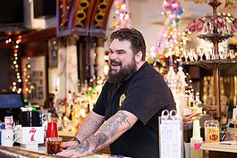 Jason Collins, the owner's son, works behind the bar at the Brass Rail Bar in Port Huron.
