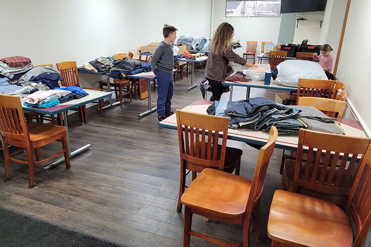 Volunteers sort clothing in the dining room at Blue Water Area Rescue Mission.