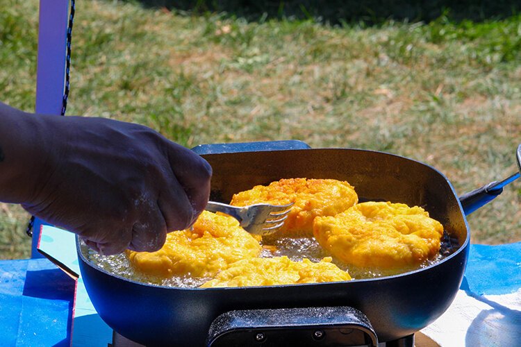 A vendor at the 2022 Blue Water Traditional Pow-Wow cooks fry bread.