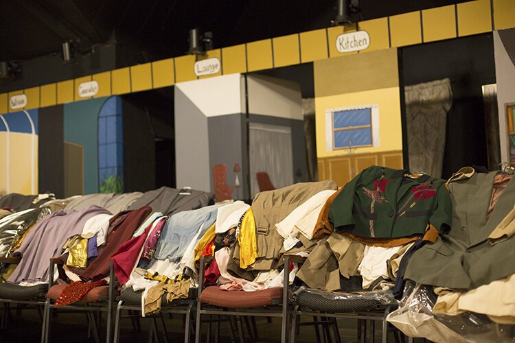 While the costume room is being renovated, costumes have been placed over chairs on the stage at the Richmond Community Theatre (RCT) where the set for the postponed production Clue the Musical is set up and ready for reopening.