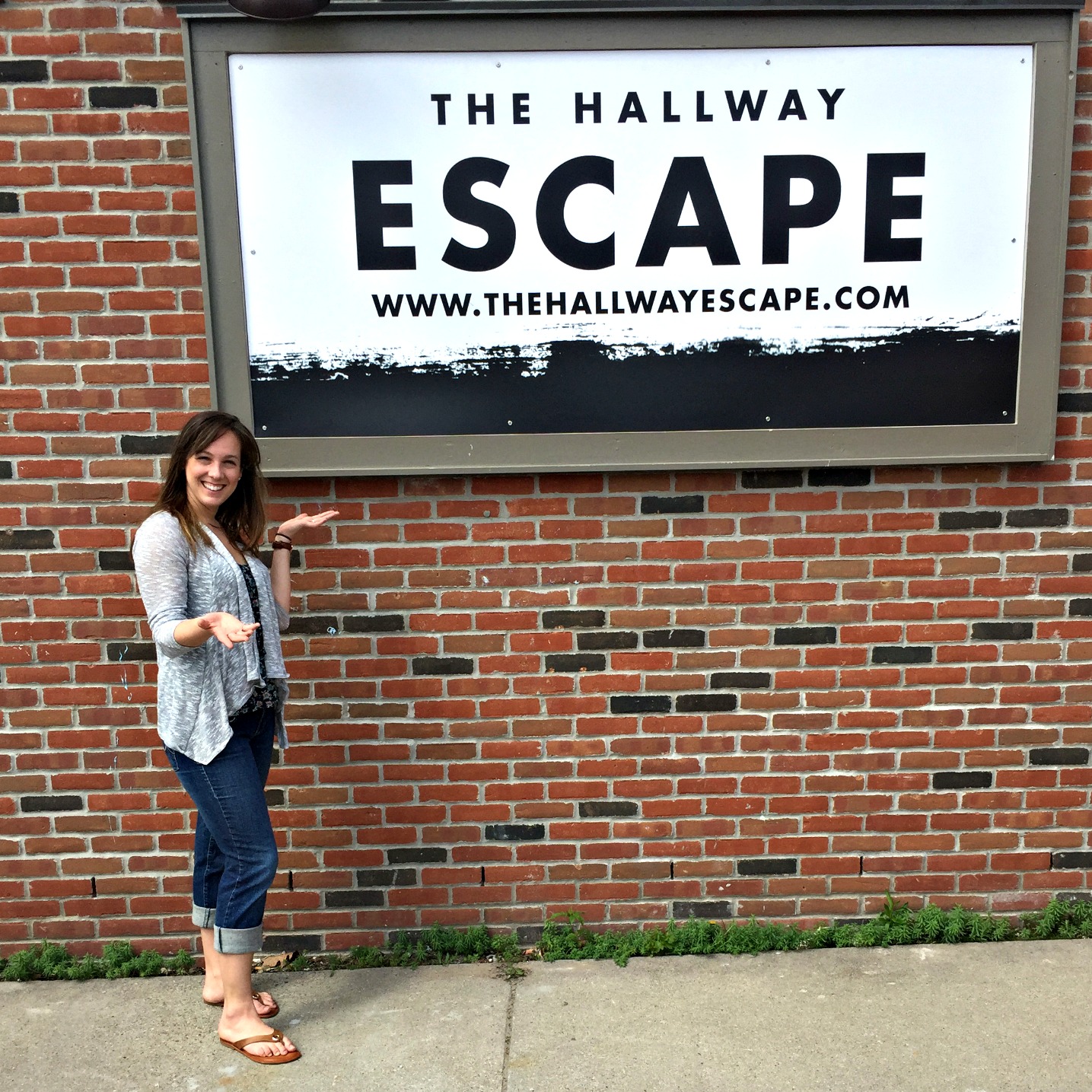 Carol Hall stands outside her new business, The Hallway Escape, in downtown Port Huron.