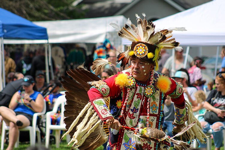 Men's traditional dance participants perform during Clay Days in traditional regalia.