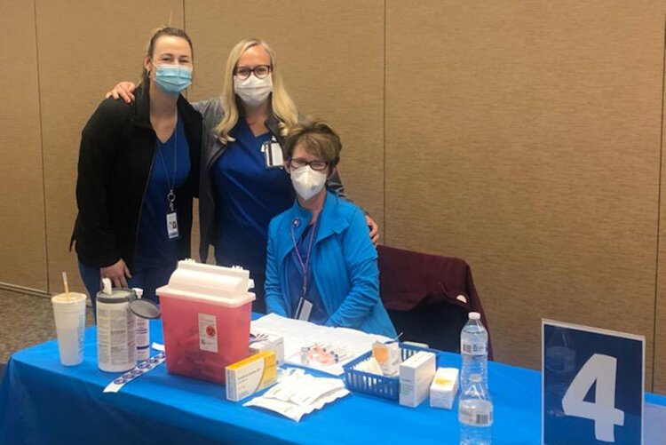 (From left) SCCCMH nurses Lauren Higgins, Melissa Nicholson, and Mary Croteau, prepare for a vaccination clinic. Offering vaccination clinics on-site with nursing staff works to eliminate barriers to care for some individuals receiving CMH services.