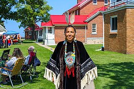 Eagle Staff Carrier, Patricia Shawnoo, poses for a photo during the 2023 Blue Water Traditional Pow-Wow.