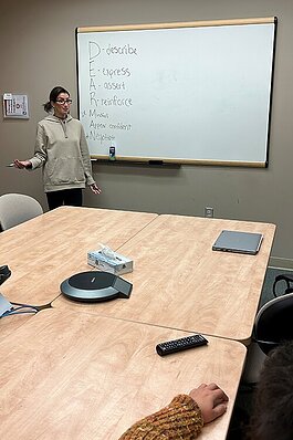 Alexandra Gabridge, DBT and Outpatient Clinician with St. Clair County Community Mental Health, goes over skills with an individual in the Dialectical Behavior Therapy program during a group session.